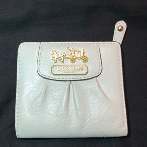 Coach Women’s white leather wallet.